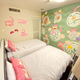 Two beds close to the wall, which is covered in Slowpoke.